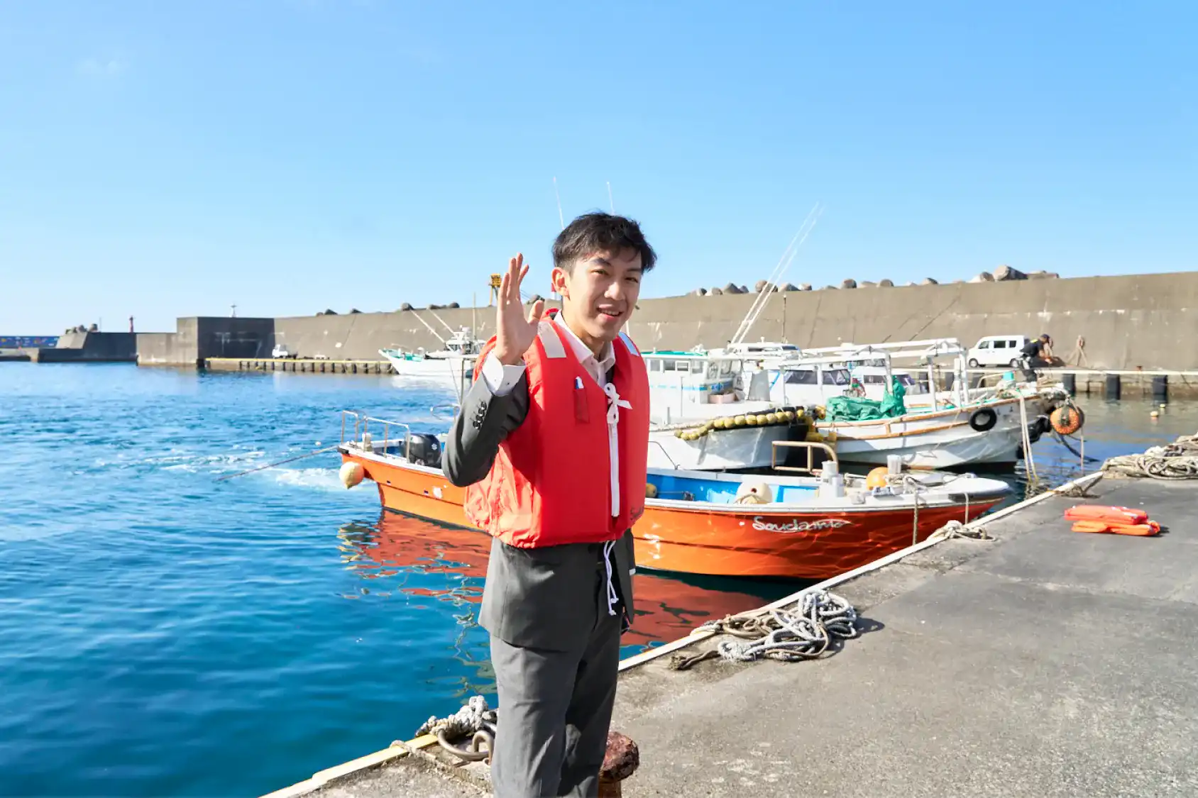 港から漁船に乗り込むスーツさん