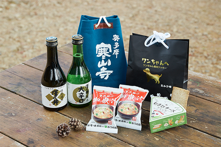 右上から時計まわりに「ワンちゃんへ ワンちゃん専用クッキー ミルク味」、「わさびチーズディップ」、「御嶽汁フリーズドライ」、「澤乃井」の「特別純米 澤乃井」と「純米大辛口」のセット。